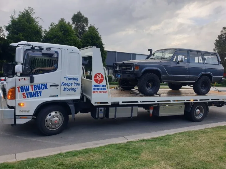 Tow truck transporting off-road vehicle